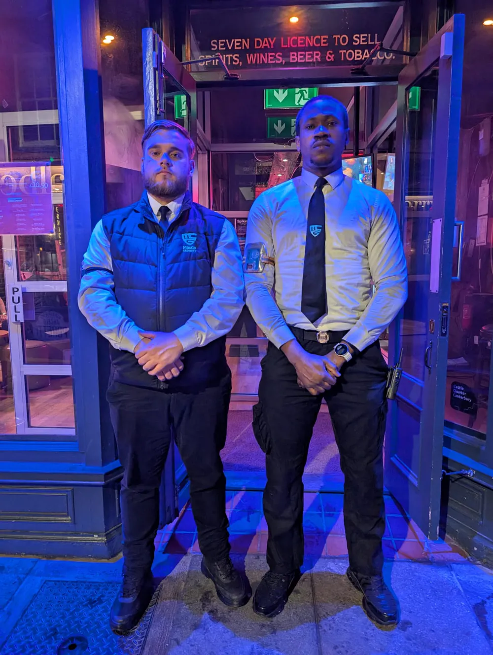 MavCo door supervisors on a venue entrance at night